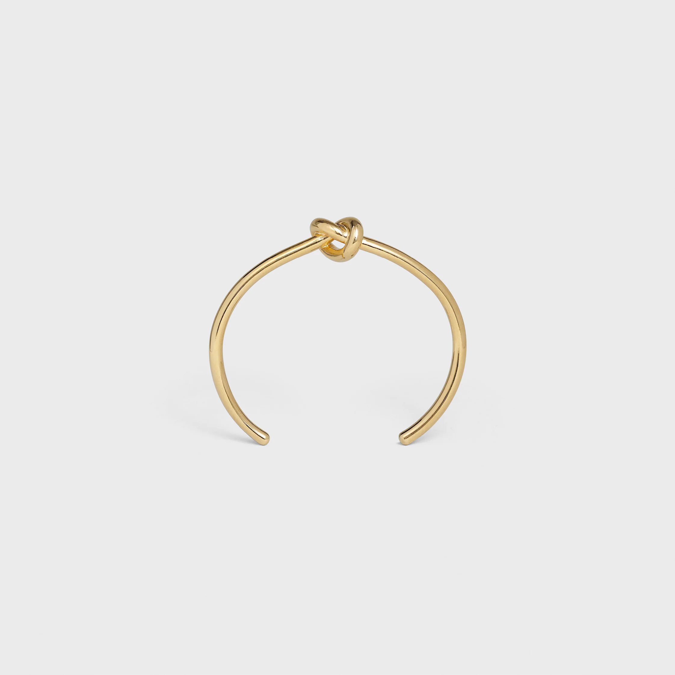 Brazalete extrafino con nudo en latón con acabado dorado