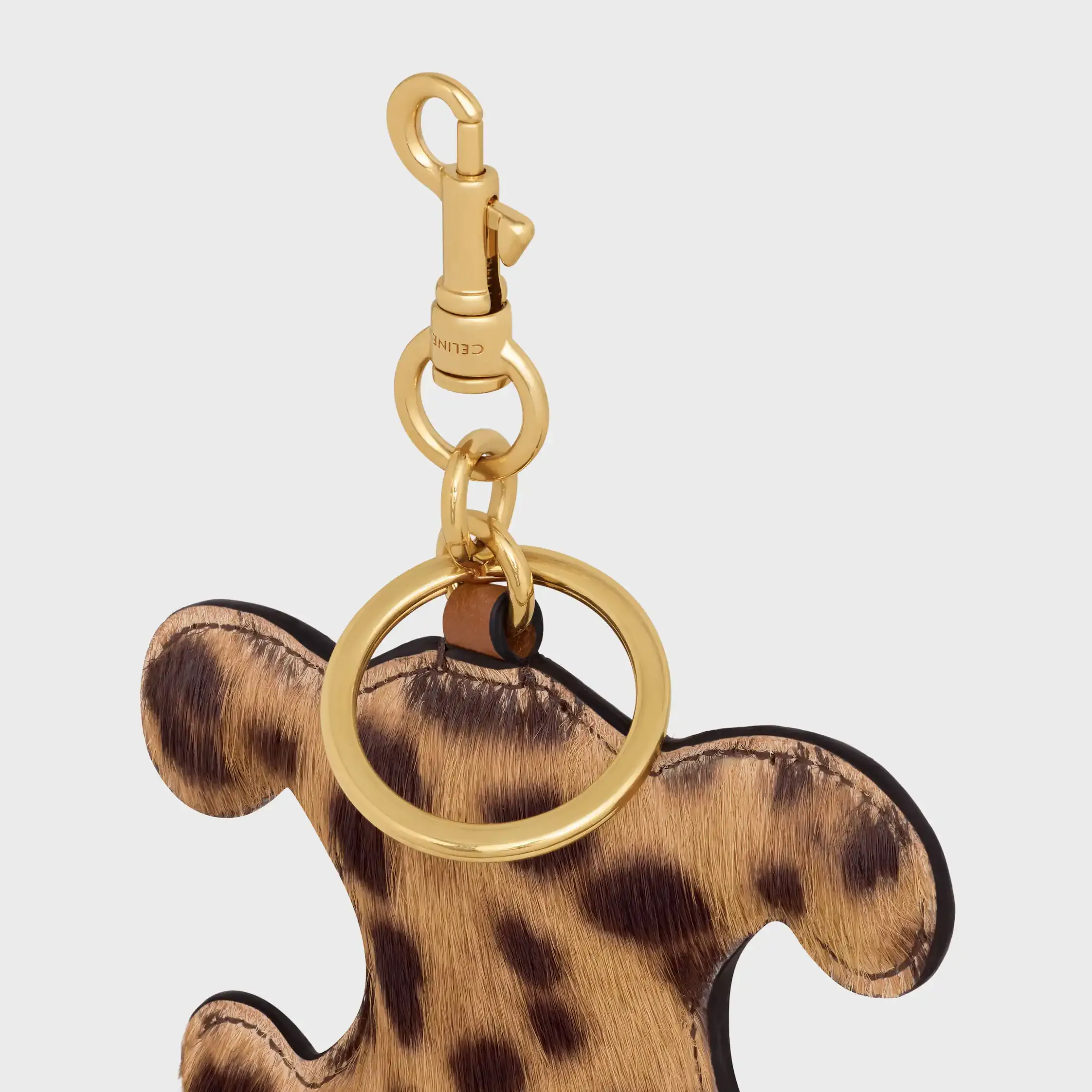 Llavero con pompón TRIOMPHE en PONY con estampado de leopardo y cuero de ternera